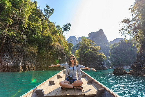 Worldwide Travel - Lady sat in canoe boat